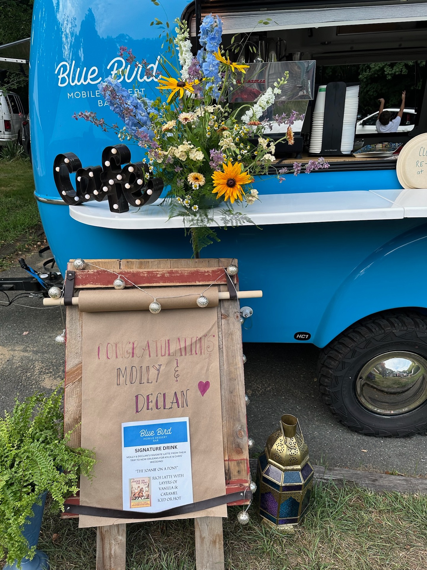 Blue Bird camper with congratulations sign for Molly and Declan