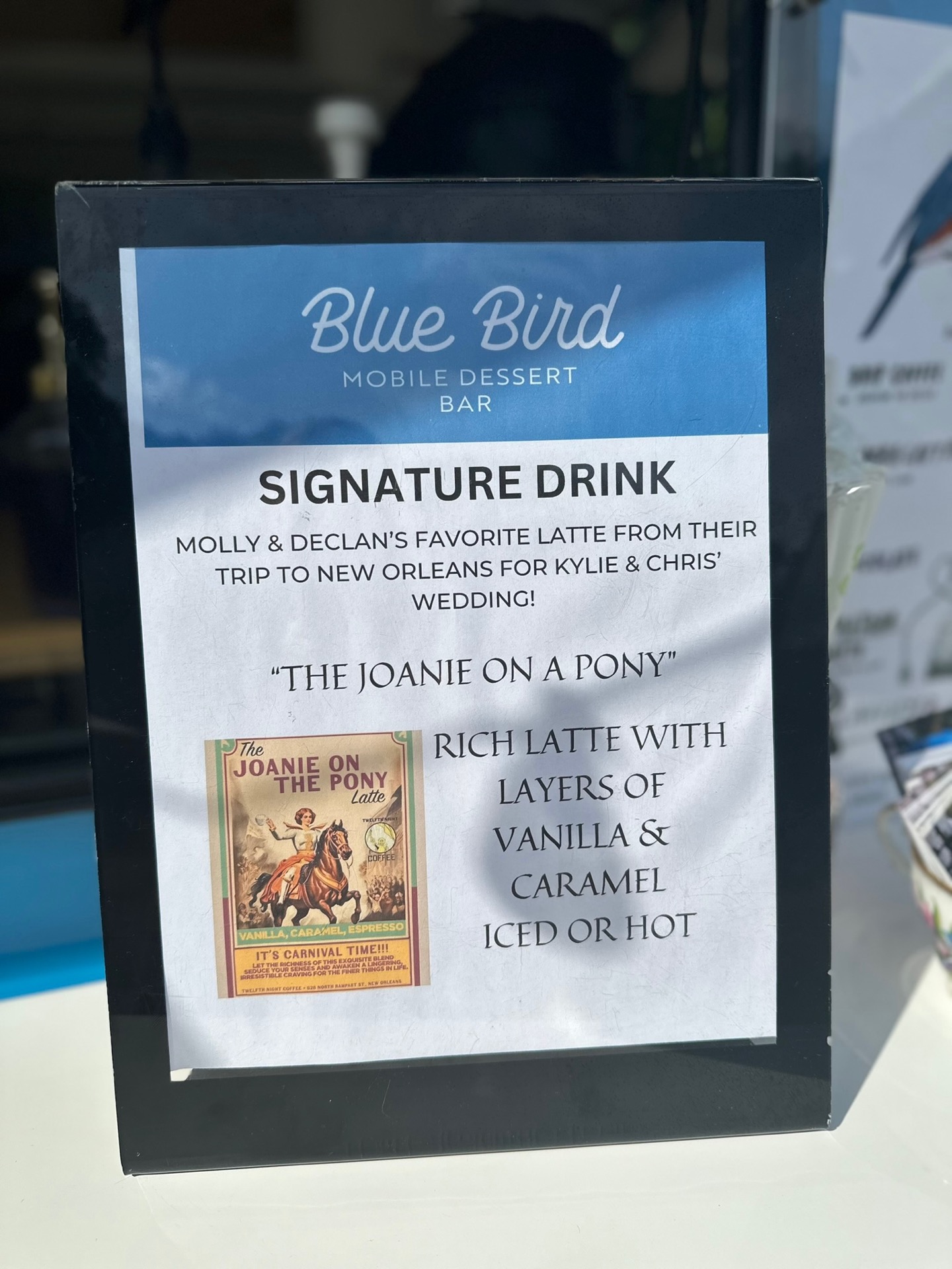 Blue Bird signature drink menu for "The Joanie on a Pony" — a rich vanilla and caramel latte