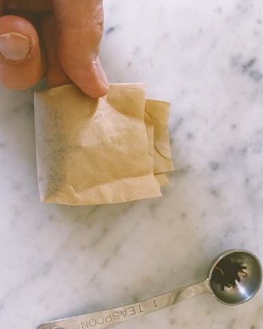 Filled tea bags ready to fold